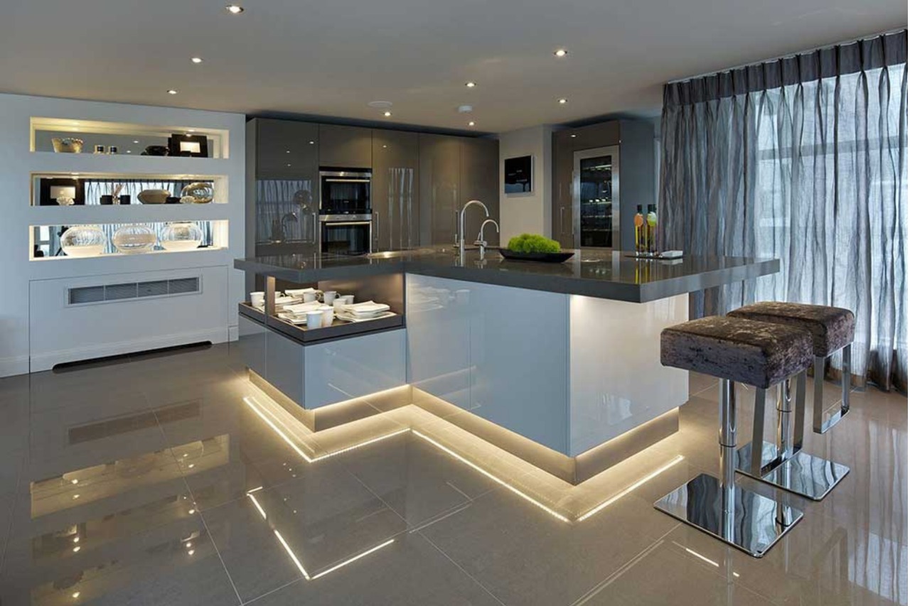A modern Bespoke kitchen in London with a large island and lighting.