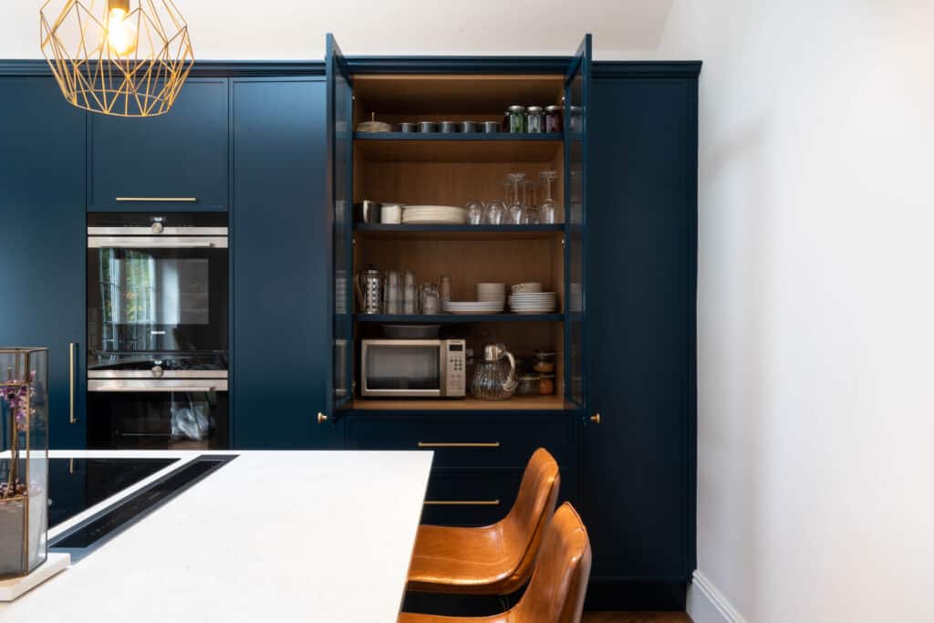 A bespoke London kitchen featuring wooden table and chairs.