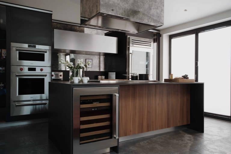 A stylish London kitchen featuring stainless steel appliances and bespoke wood works.
