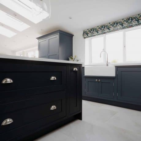 A bespoke kitchen in London with wooden cabinets and a skylight.