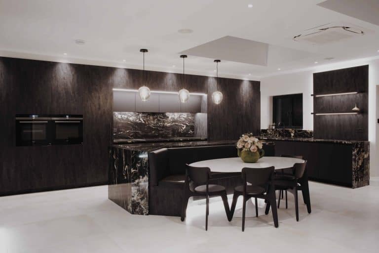 A bespoke black and white kitchen with marble counter tops in London.